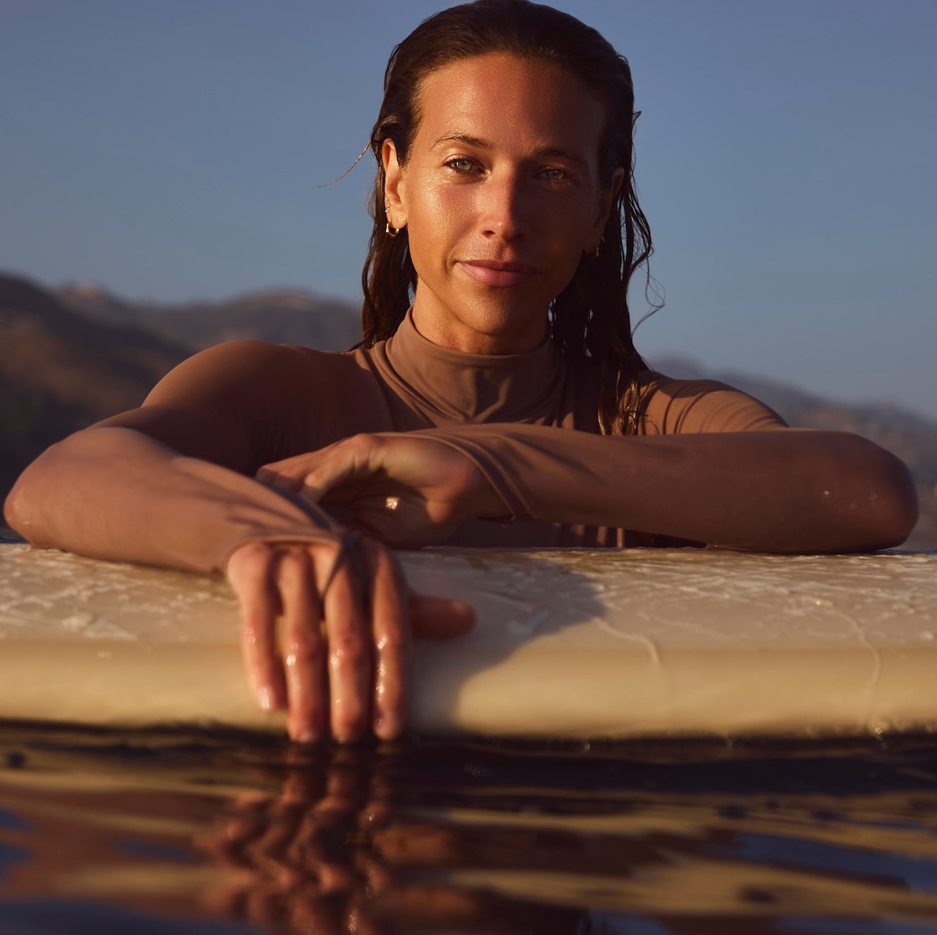 female surfer in water with surfboard