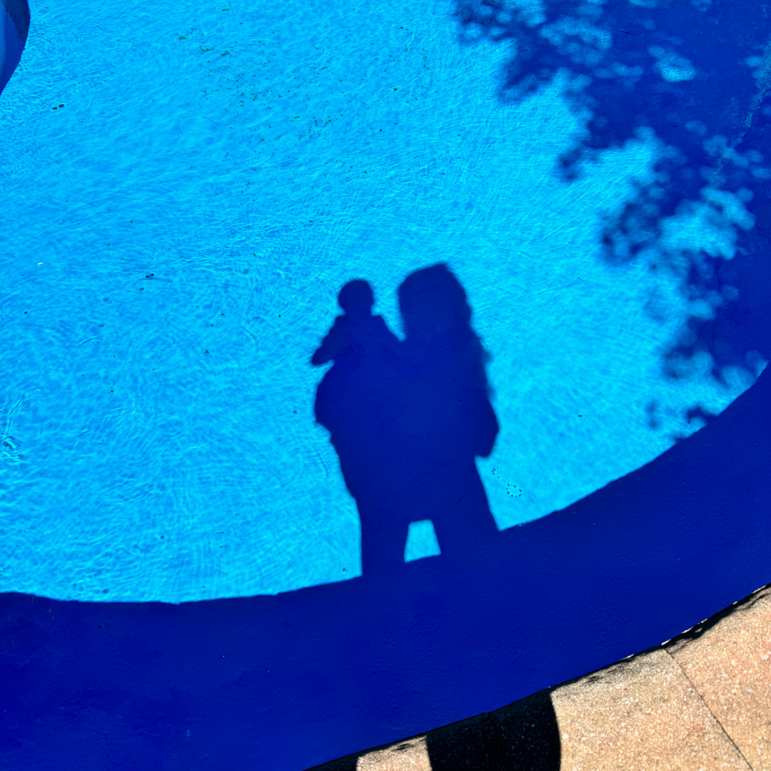 mom and baby's shadow in blue pool