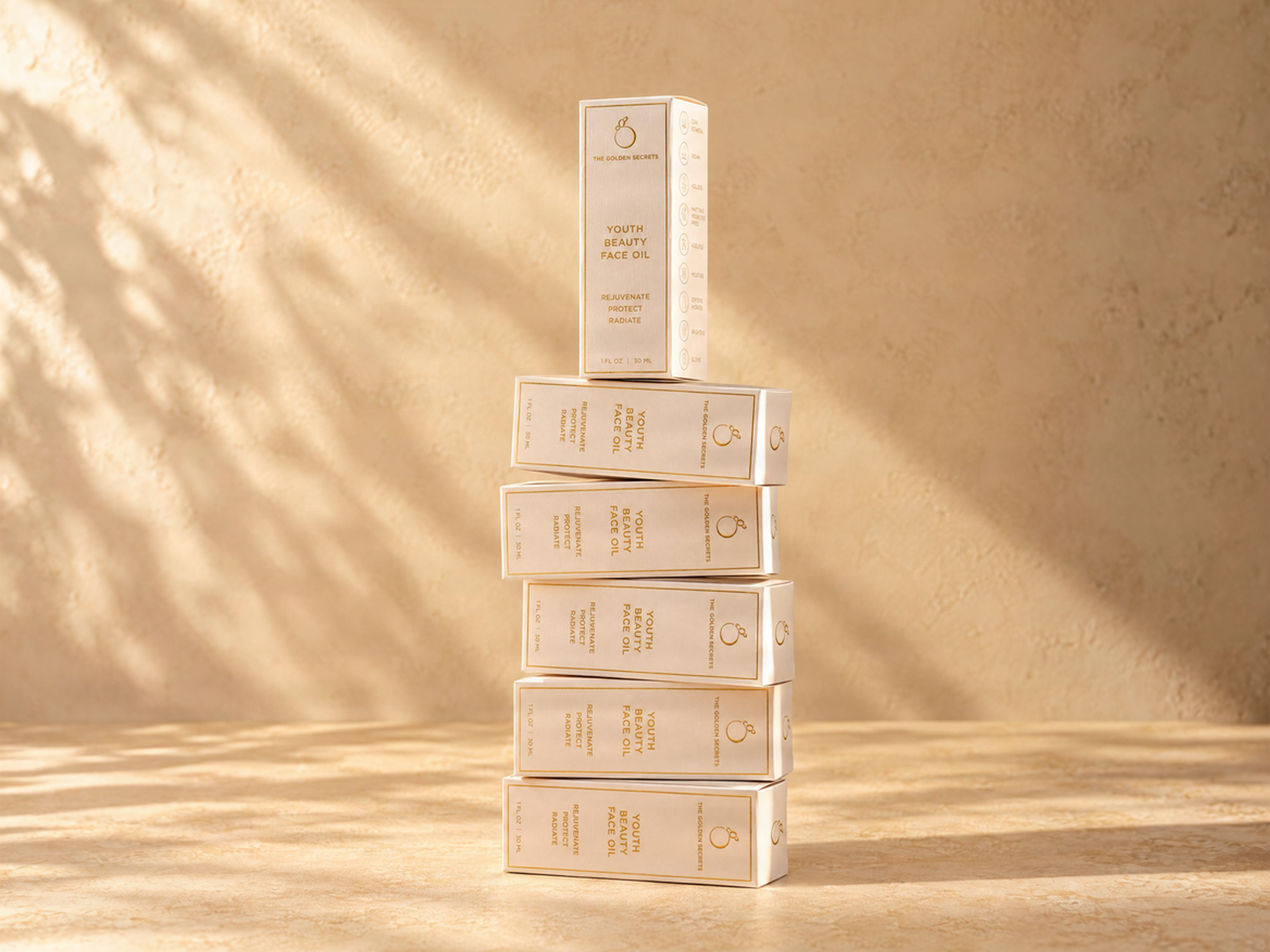 A stack of five beige boxes of The Golden Secrets Youth Beauty Face Oil.