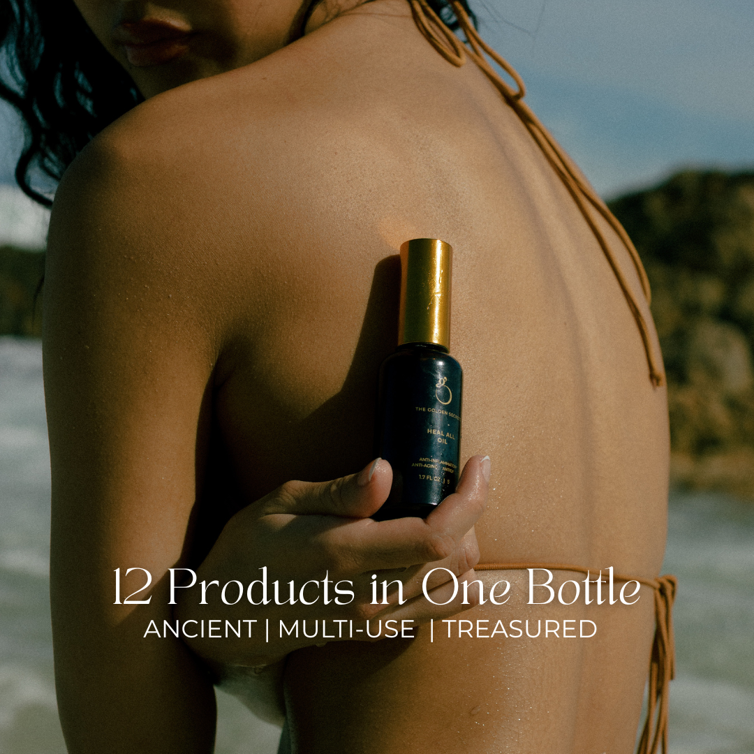 woman on beach holding heal all oil