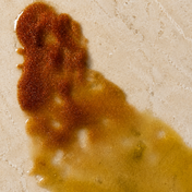 Brown and yellow stain on a beige surface