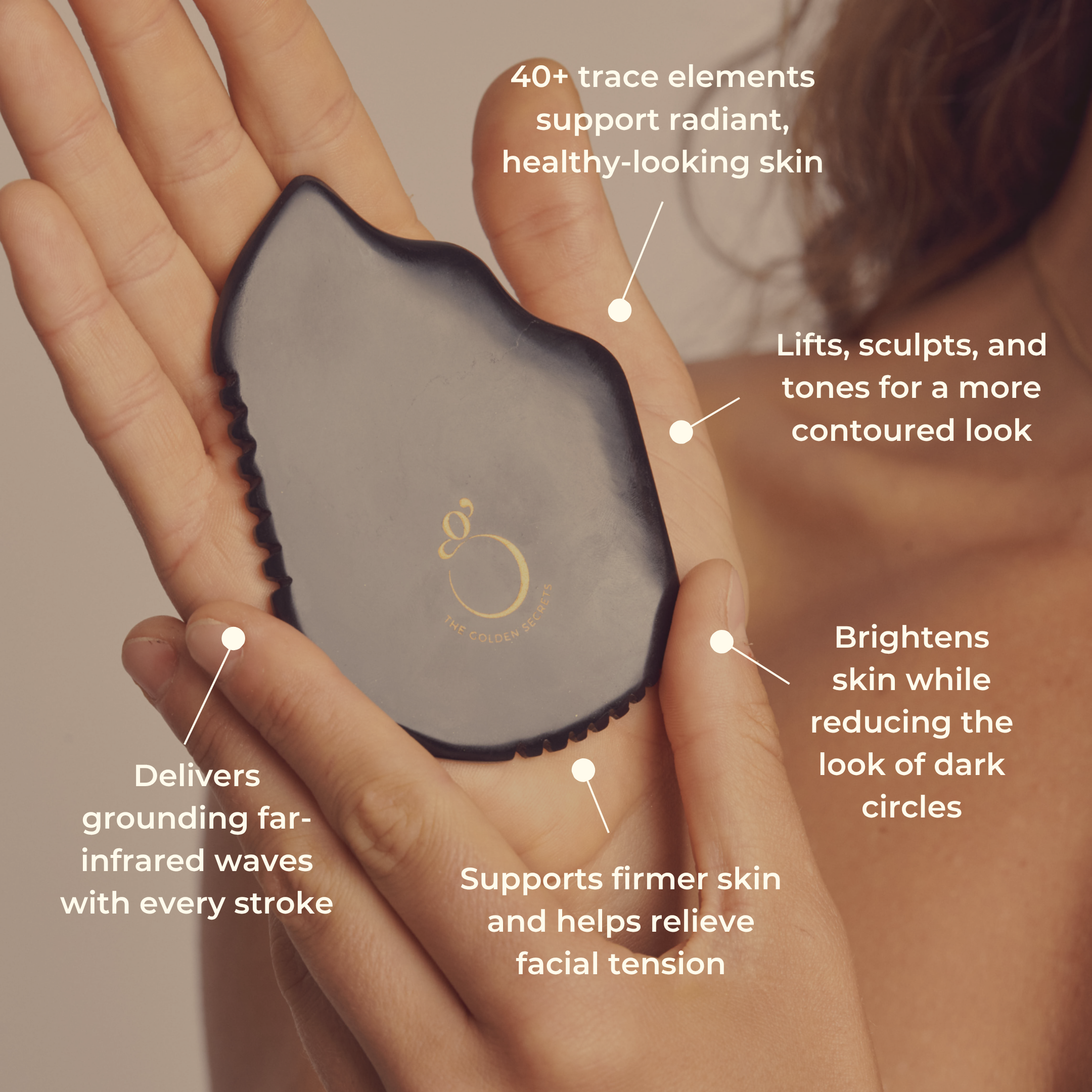 A hand holds THE GOLDEN SECRETS Sorceress Stone Gua Sha Beauty Tool in black, with text highlighting its benefits such as supporting healthy skin, lifting and sculpting for more defined facial contours, brightening the complexion, reducing dark circles, and relieving facial tension.