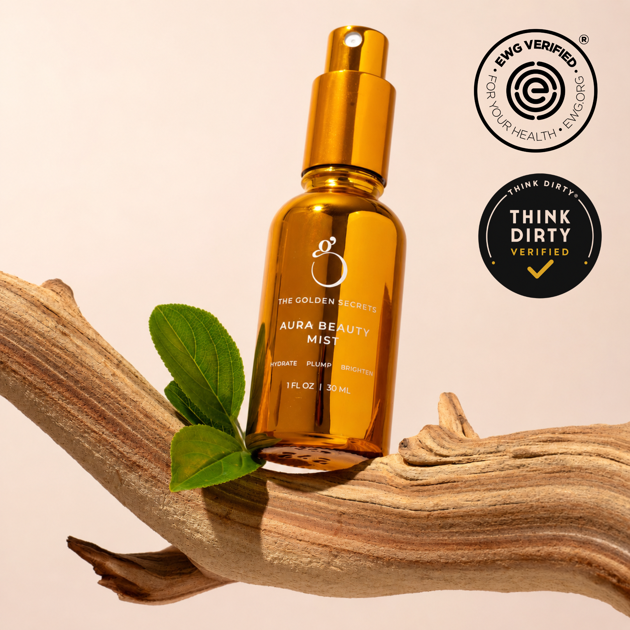 A brown bottle labeled “Hydrate & Heal Duo” from THE GOLDEN SECRETS rests on a curved piece of wood alongside a green leaf, emphasizing its gentle formula ideal for sensitive skin. EWG VERIFIED and THINK DIRTY VERIFIED seals are displayed in the top right corner, set against a neutral light background.
