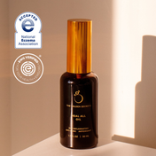 A bottle from THE GOLDEN SECRETS Hydrate & Heal Duo is displayed under golden lighting, emphasizing its gentle formula created for sensitive skin. Beside it are the National Eczema Association Accepted and EWG Verified logos, underscoring its dedication to maintaining a healthy skin barrier.