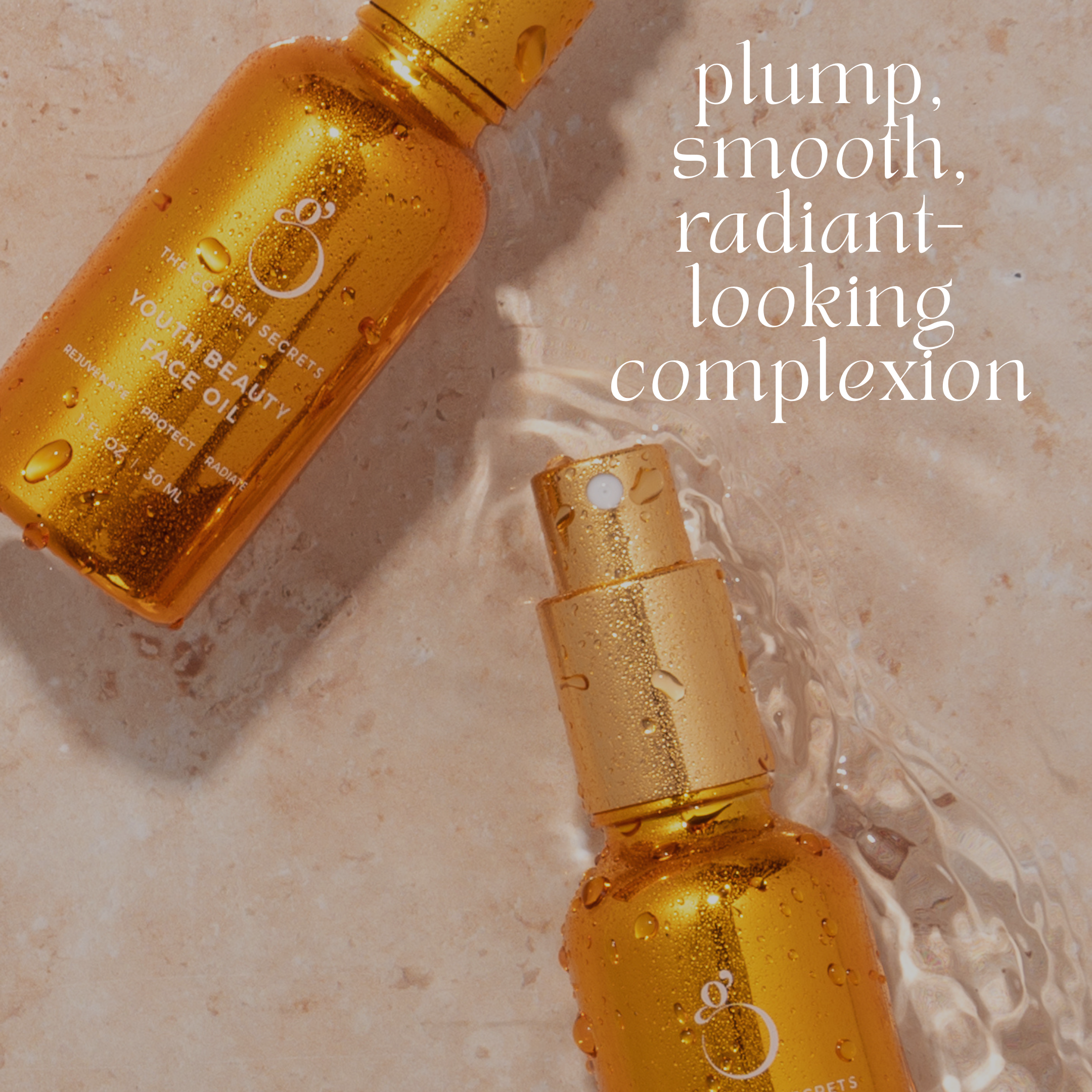Two golden bottles of face oil from THE GOLDEN SECRETS Ultimate Glow Trio Kit rest on a beige surface with water splashing around them. Text reads: plump, smooth, radiant-looking complexion—your secret to radiant skin.