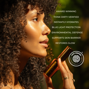 A woman with curly hair holds THE GOLDEN SECRETS Five-Minute Facelift Kit near her face as part of her daily skincare ritual. Beside her, a list of the kit’s benefits highlights hydration, blue light protection, and skin barrier support for glowing skin. The EWG Verified logo is displayed.