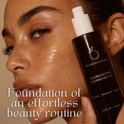 A woman with glowing skin applies a golden cleansing oil to her cheek. She holds a brown bottle labeled Cleansing Ritual Kit by THE GOLDEN SECRETS. Text reads: Foundation of an effortless beauty routine and proper cleansing to remove makeup with ease.