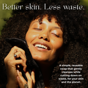 A person with curly hair smiles joyfully while holding a soft black cloth to their face. Text reads, Better skin. Less waste. and promotes THE GOLDEN SECRETS Cleansing Ritual Kit—a reusable skincare essential designed for effective makeup removal and a sustainable cleansing routine, making it the perfect addition to your ritual kit for proper cleansing and environmental benefits.