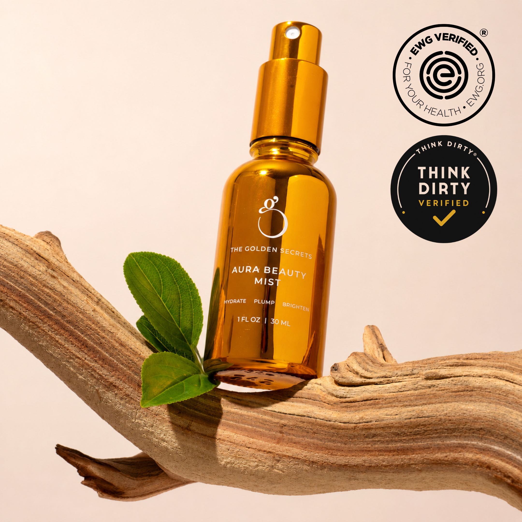 Amber spray bottle labeled THE GOLDEN SECRETS Clear Confident Skin Kit rests on a driftwood branch with green leaves, featuring EWG Verified and Think Dirty Verified certification badges on a beige background—ideal for those seeking radiant-looking skin and gentle blemish treatment.