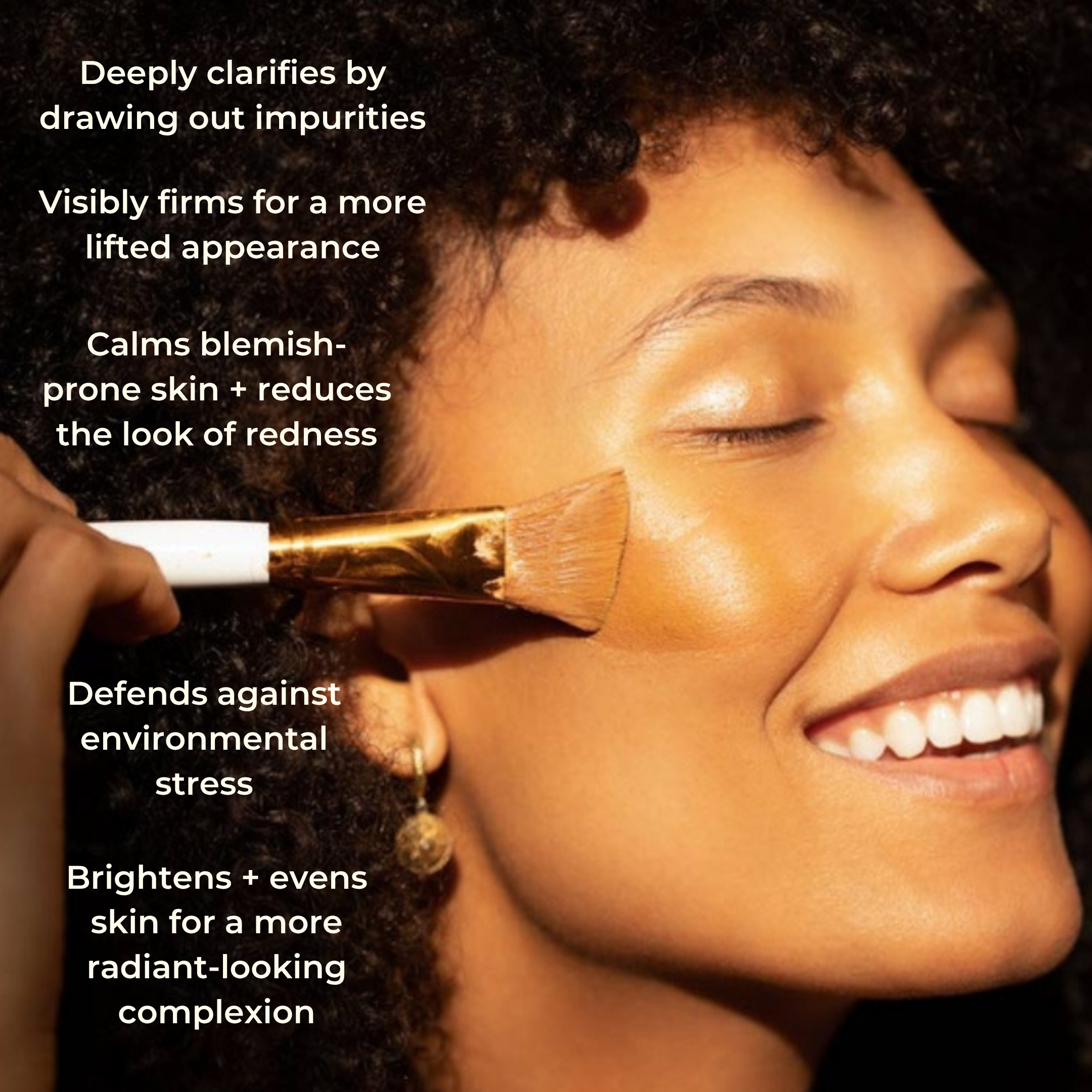 A woman with glowing, radiant skin smiles as she applies makeup with a brush. The Golden Secrets Clear Confident Skin Kit offers skincare benefits that clarify, firm, calm, defend against stress, brighten, and even skin tone for a clearer complexion. Plus, this kit is Think Dirty Verified.