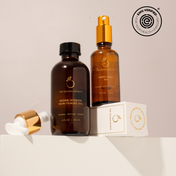 Two amber skincare bottles from THE GOLDEN SECRETS—one labeled Mom & Baby Womb Wisdom Skin-Toning Oil, the other Happy Baby Oil—stand on a box, creating an ideal nourishing duo for mom’s changing skin and baby’s delicate barrier. Beside them rests a dropper with a gold cap, while the EWG Verified logo appears in the top right corner.