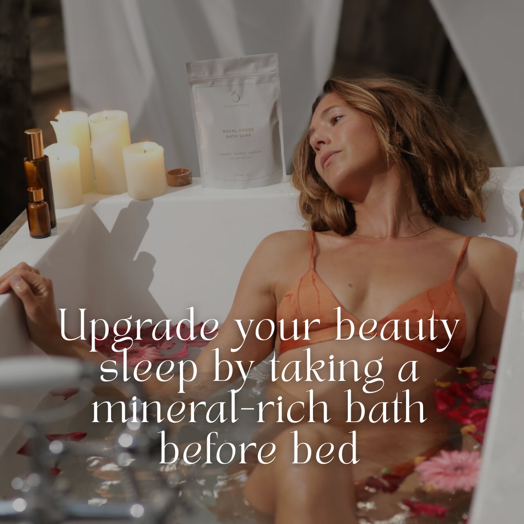 A woman relaxes in a bathtub filled with water, flower petals, candles, and Royal Codes Bath Soak by THE GOLDEN SECRETS, with text overlaid about taking a mineral-rich bath before bed.