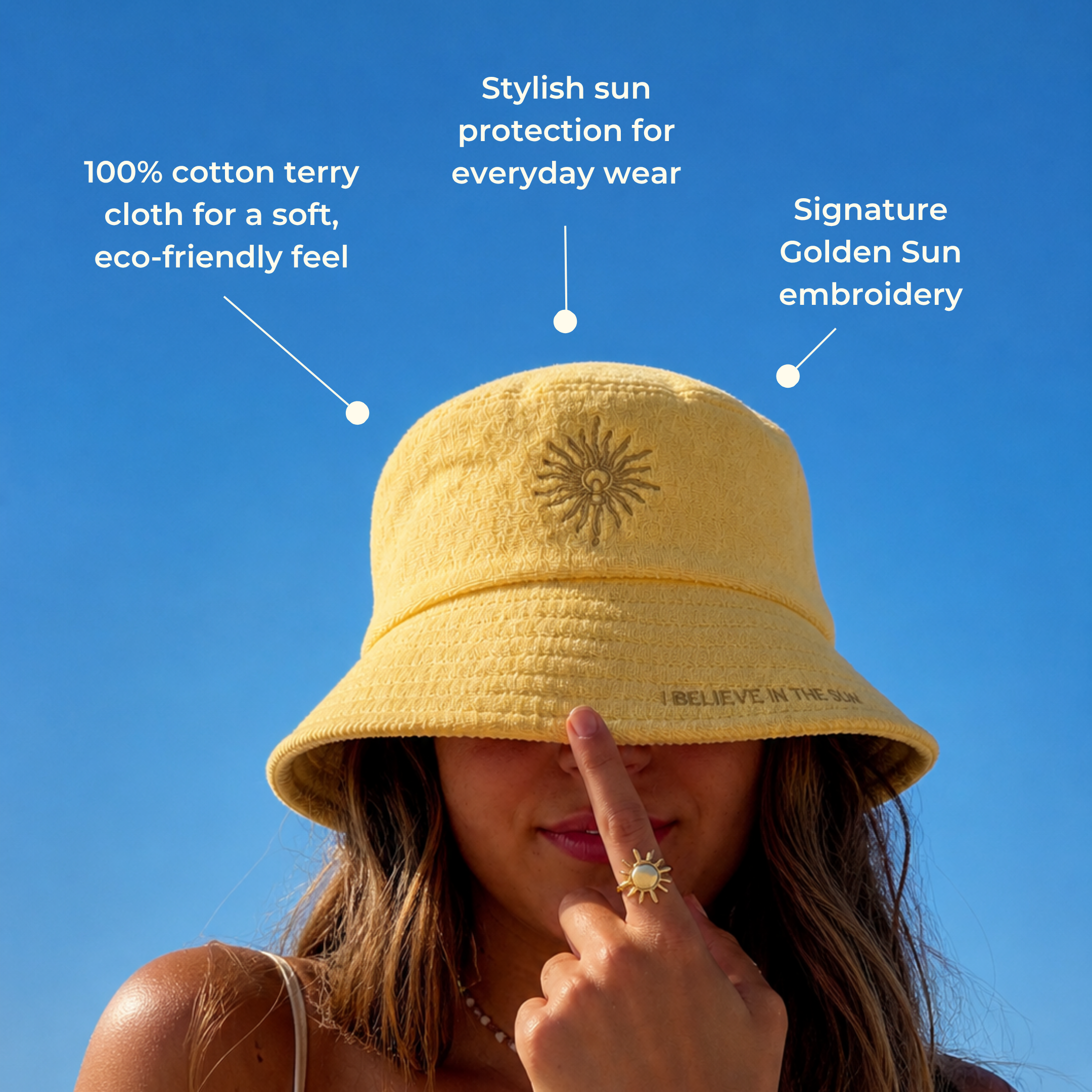 A woman models the Golden Sun Bucket Hat against a blue sky. Text spotlights its eco-friendly cotton terry cloth, stylish sun protection, and signature embroidered golden sun design.