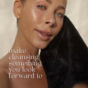 woman with glowing facial cleansing cloth
