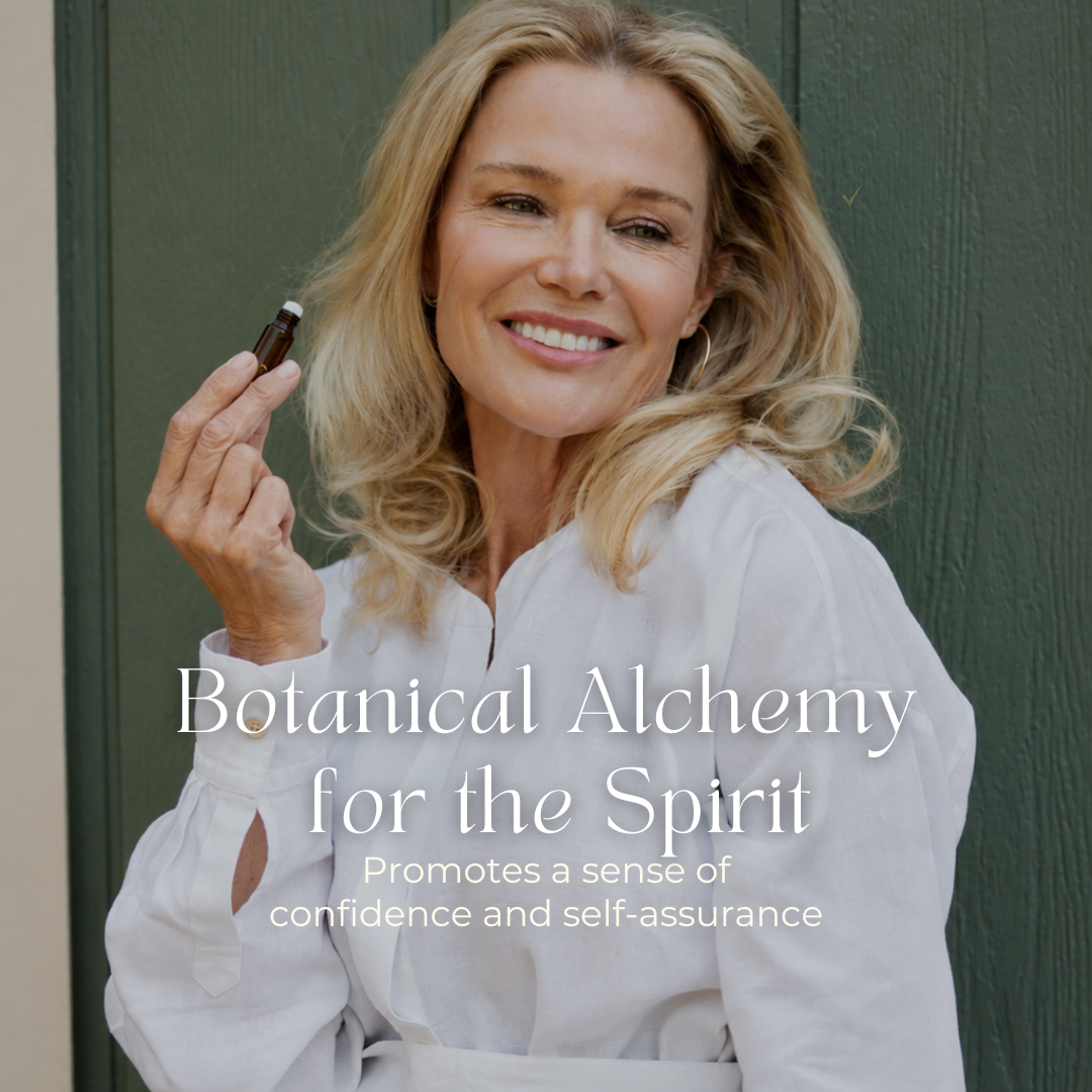 A smiling woman in a white blouse holds a small bottle of THE GOLDEN SECRETS Signature Blend Essential Oil. Text on the image reads, Botanical Alchemy for the Spirit. Harnessing the power of botanical aromatherapy, this blend promotes a sense of confidence and self-assurance. She stands in front of a green door.