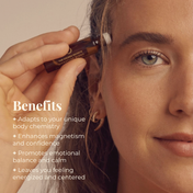A woman applies THE GOLDEN SECRETS Signature Blend Essential Oil to her temple with a small roller bottle. Text reads: Benefits—crafted with organic, botanical aromatherapy ingredients, adapts to your body chemistry, enhances confidence, promotes balance and calm, leaves you feeling energized and centered.